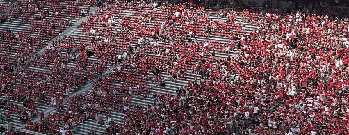 A sea of fans in red filling the lower stands of Sanford Stadium.