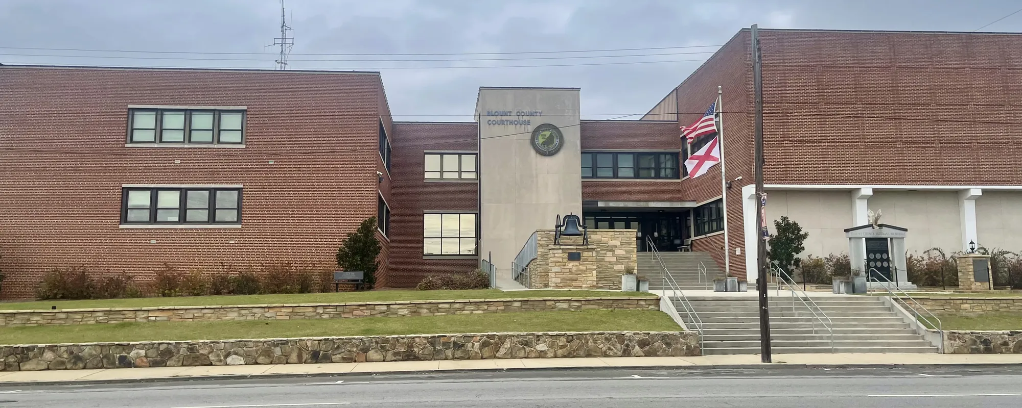 Brick county courthouse building with a flag in front