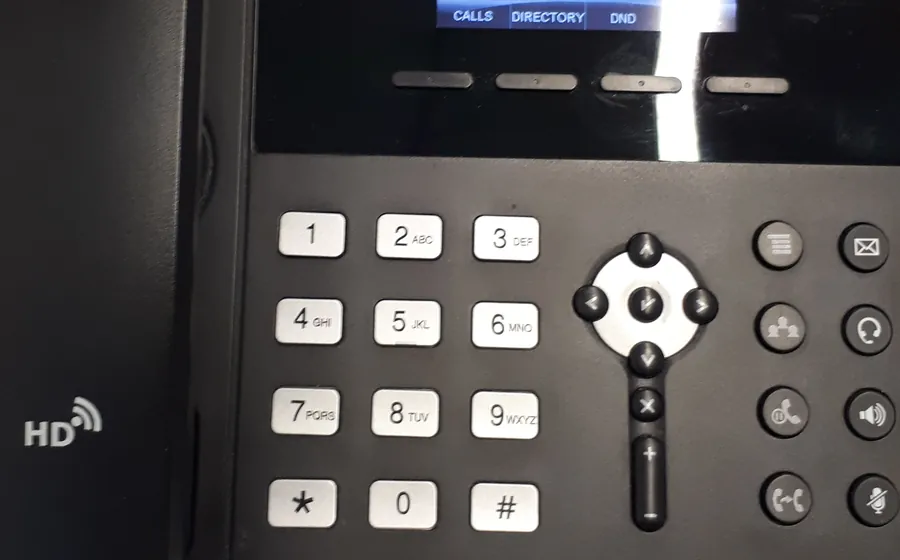 Close-up of a desk IP phone with a handset and keypad