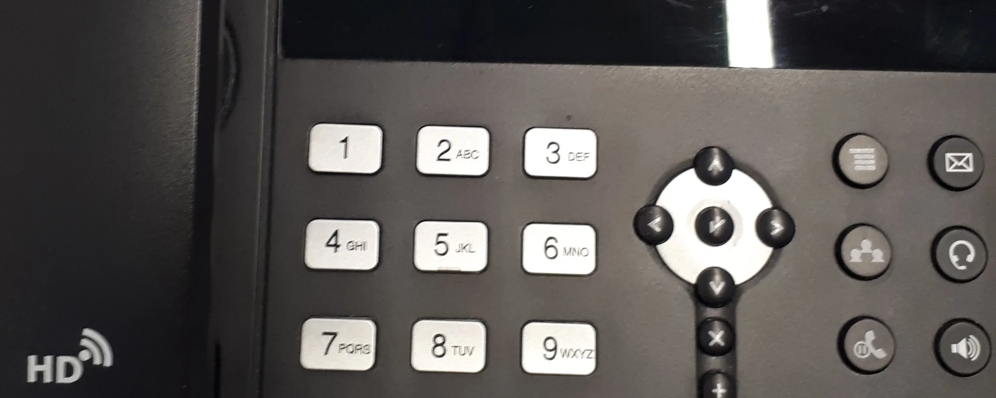 Close-up of a desk IP phone with a handset and keypad
