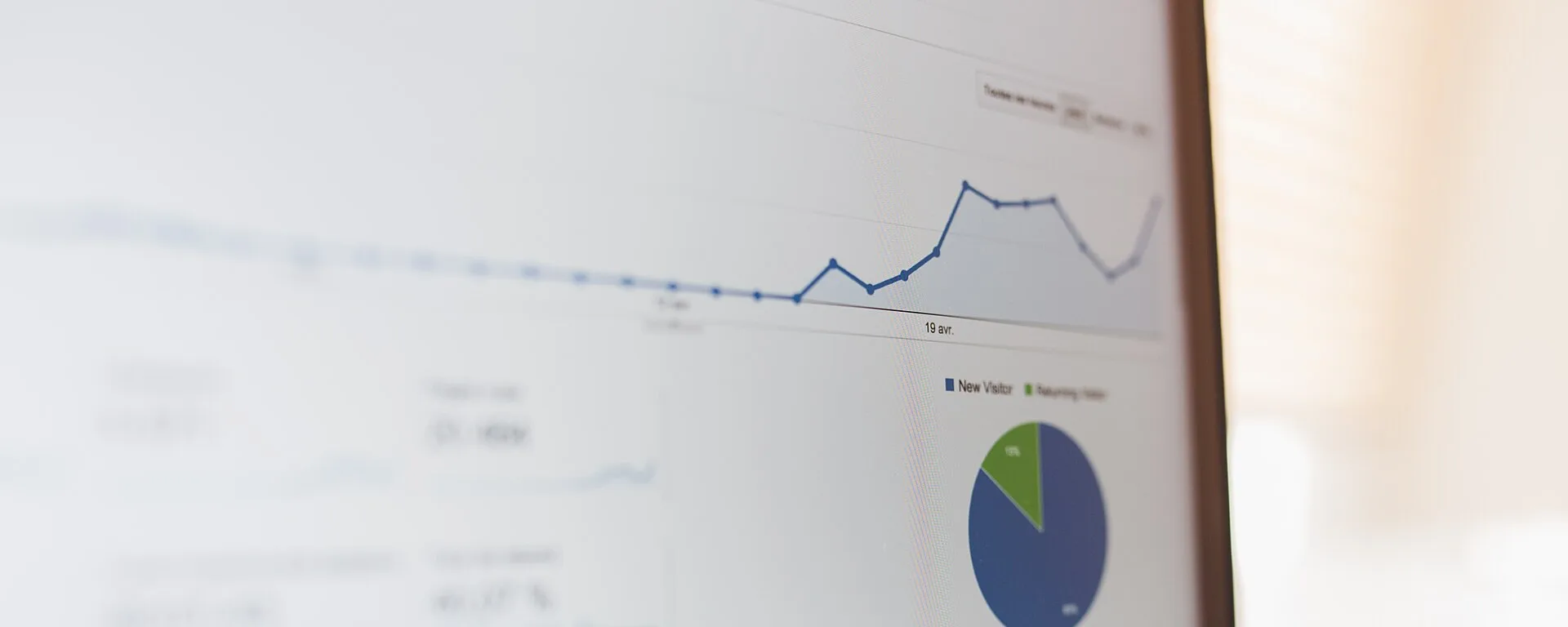 Laptop screen showing a line chart and a pie chart