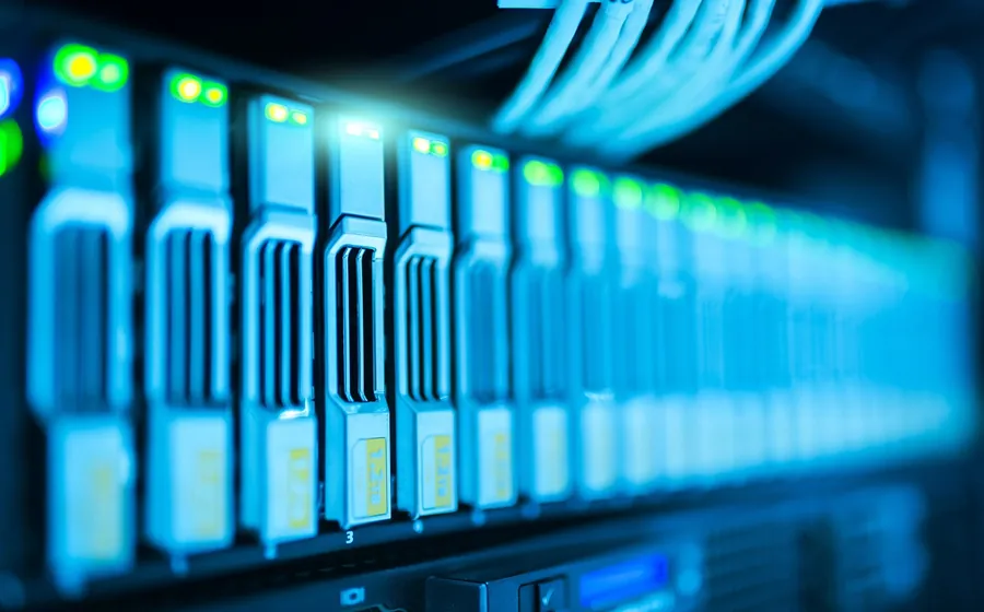 Close-up of network switch ports with blue lights and cables