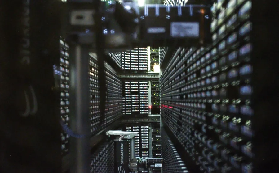 Rows of backup tape cartridges inside an automated tape library
