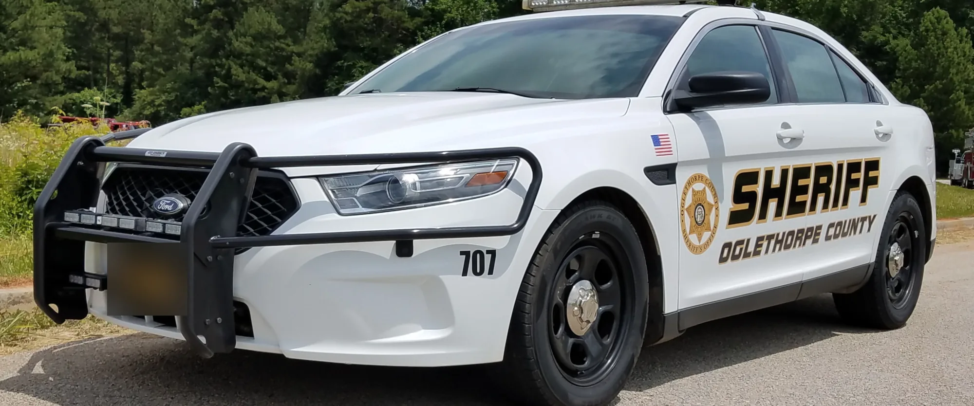 White Oglethorpe County Sheriff patrol car, unit 707, with gold Sheriff lettering and badge decal